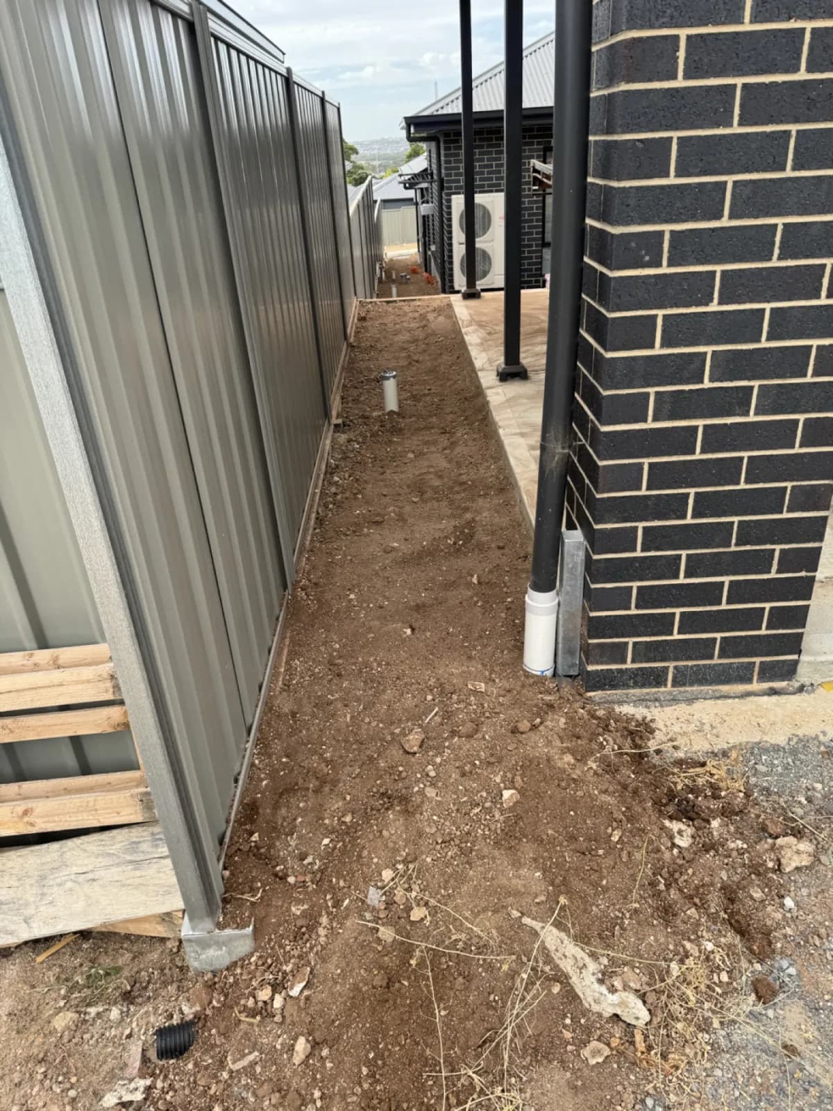 Custom drainage solution for split level block property in Glenelg
